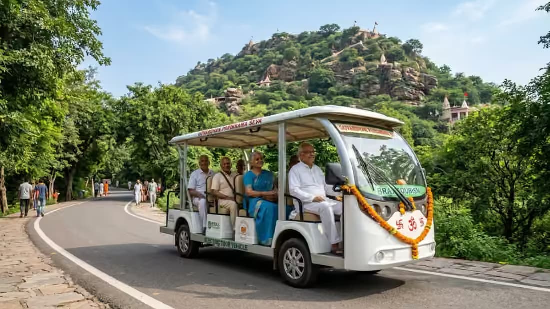 Comfortable open-air electric passenger vehicle and AC cab carrying senior citizen devotees on Govardhan Parikrama Marg with holy hill in background